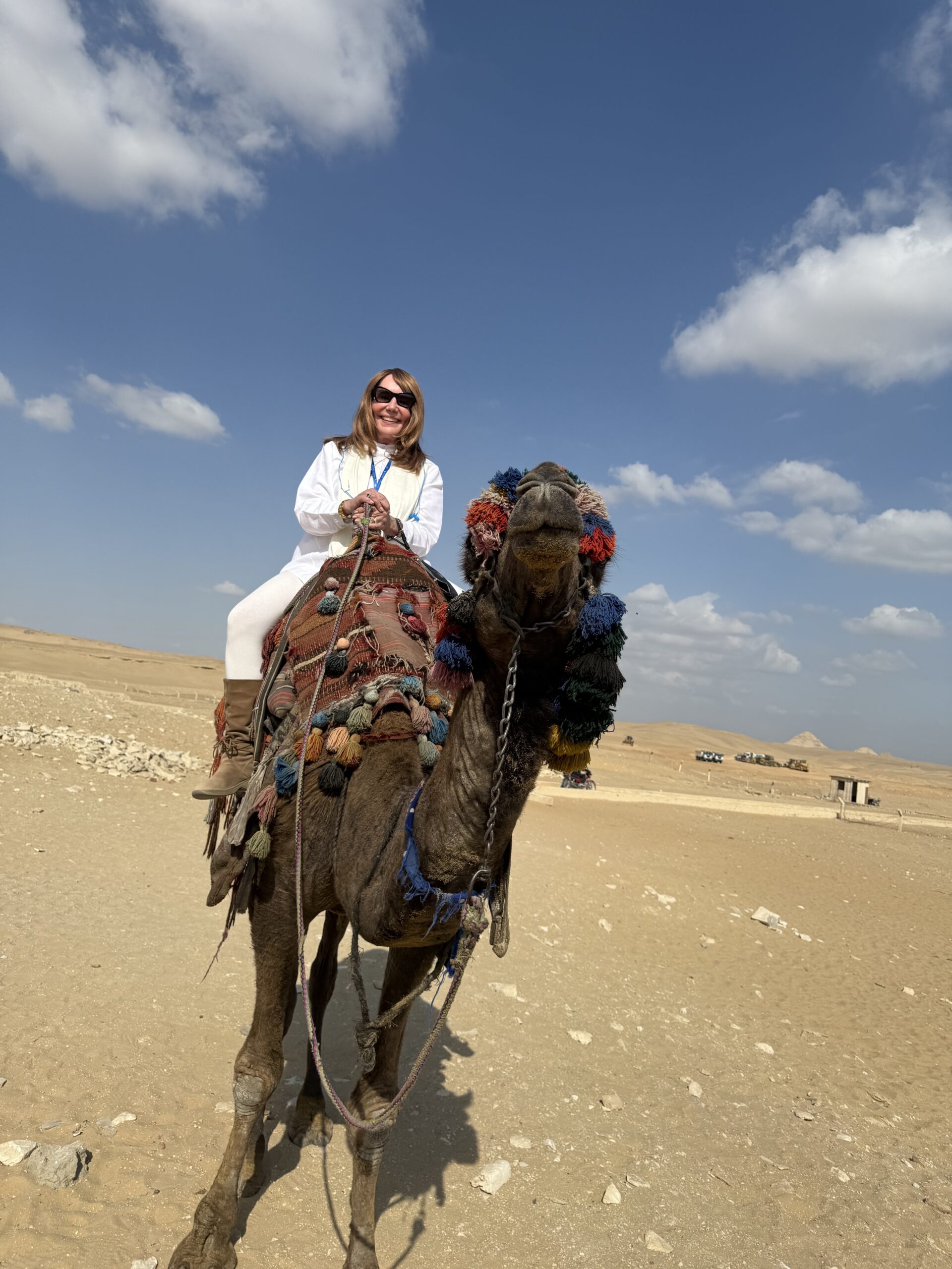 riding camels 2025 Debra Stangl riding a camel in Egypt.